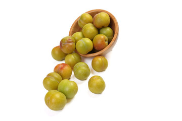Ripe sweet small mini plum green maroon on white background