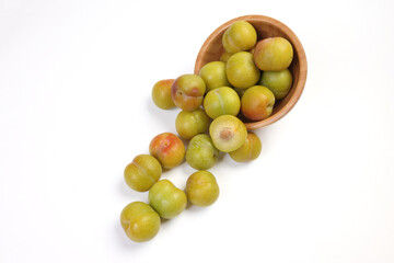 Ripe sweet small mini plum green maroon on white background
