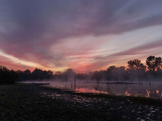 Sky colors at sunrise in the morning fog over the water