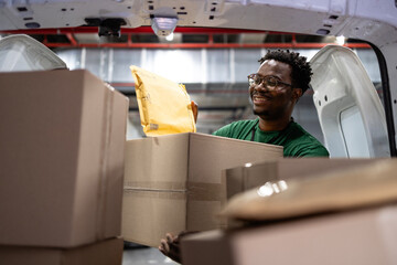 Shipping worker arranging packages and mail inside postal sorting facility.