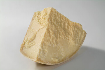 Large slice of parmesan cheese on white background