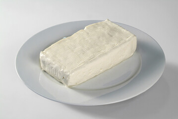 Plate with soft cheese, on white background
