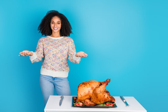 Photo portrait of attractive young woman hands hold empty space celebrate thanksgiving dinner turkey isolated on blue color background