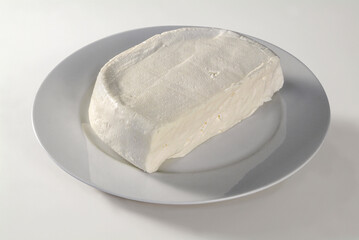 Plate with soft cheese, on white background