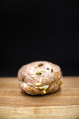 Donut with pistachio filling, tasty sweet.
