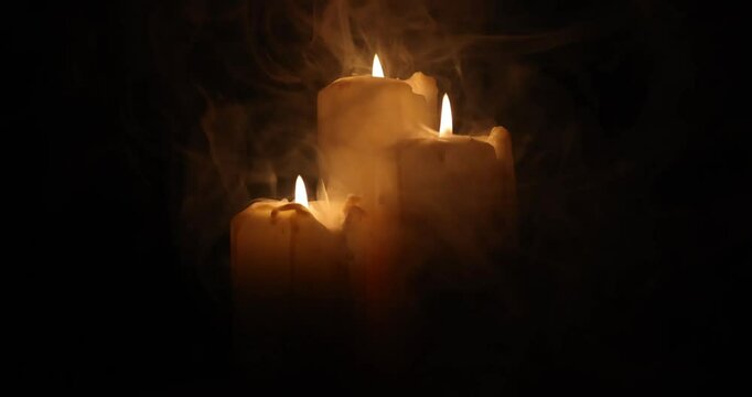 Lit candle flame through heavy smoke fog mist vapour flow twist beautiful mistic