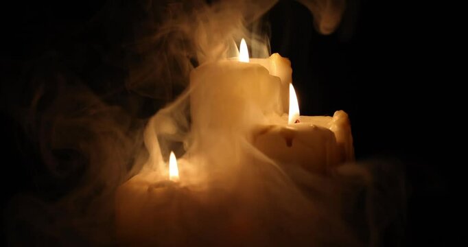 Lit candle flame through heavy smoke fog mist vapour flow twist beautiful mistic