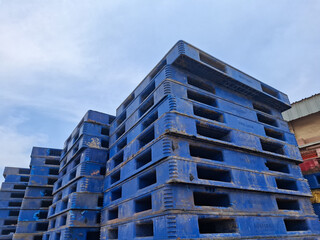 stack of empty plastic pallets in warehouse. concept of shipping and cargo goods.