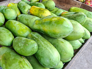 pile of green papaya fruit for sale in the market