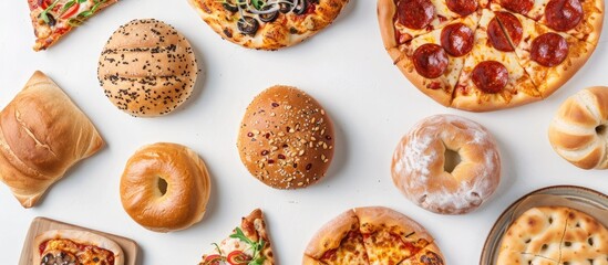 Fast food items like buns pastries pizzas and rolls are displayed from a top view with a focused arrangement and available copy space in the image on a white background
