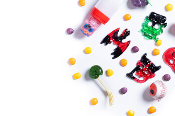 Assortment of Halloween candies isolated on white background. Top view. Copy space