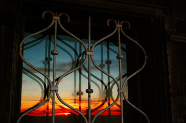Sunset behind the bars.