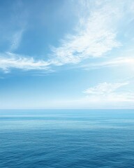 Obraz premium A calm blue seascape with a clear sky and soft clouds