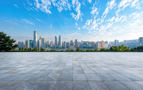 Empty marble floor overlooking modern city skyline under blue sky