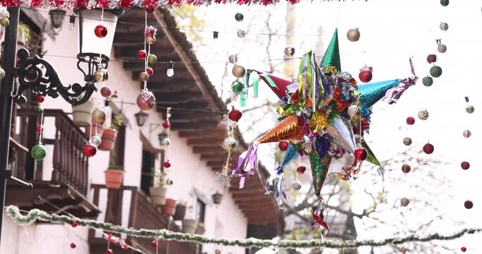 A colorful pi&ntilde;ata hangs over a historic downtown street in Mazamitla, Jalisco, Mexico.