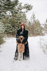 Family portrait of young happy mother walking with cute little daughter together in snowy winter...