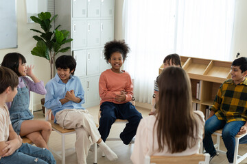 Diverse Group of Children Enjoying a Fun Activity with Teacher in Classroom
