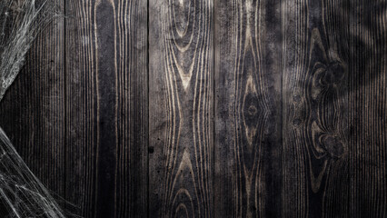 Obraz premium Spooky creepy cobweb spiders web covered a wooden background