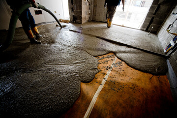 construction site, interior of apartment laying of floor screed with workers in action IMGC1605