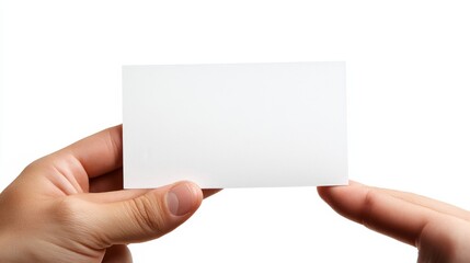Obraz premium Close-up of a hand holding a blank white business card, isolated on a white background.