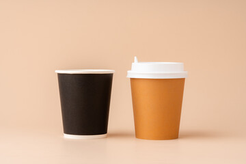 Disposable coffee cups arranged on a neutral background
