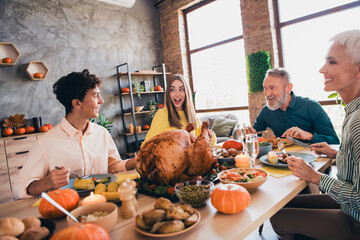 Photo of four friendly family members talk laugh eat food celebrate thanksgiving dinner apartment indoors
