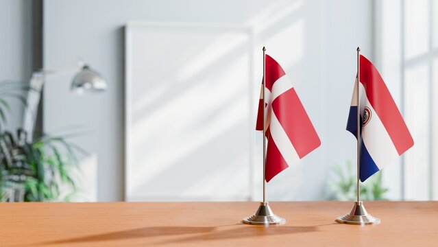 FLAGS OF DENMARK AND PARAGUAY ON TABLE