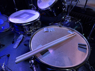 Set of drums. Detail of a drum kit closeup. The concept of a live concert. Drum set on rock concert stage. Professional musical instruments for drummer musician. Drumming instrument on rock festival.