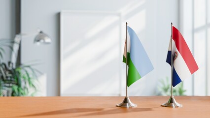 FLAGS OF DJIBOUTI AND PARAGUAY ON TABLE