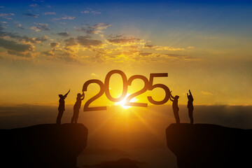 Silhouette of happy teamwork standing and touch 2025 text on beautiful sunrise backgroud celebrate...