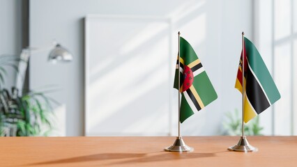FLAGS OF DOMINICA AND MOZAMBIQUE ON TABLE