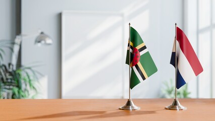 FLAGS OF DOMINICA AND NETHERLANDS ON TABLE