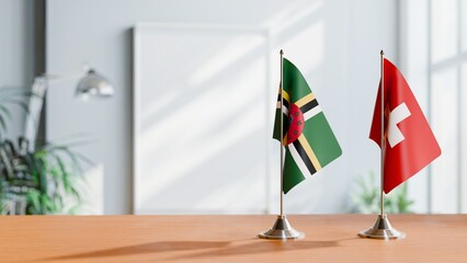 FLAGS OF DOMINICA AND SWITZERLAND ON TABLE