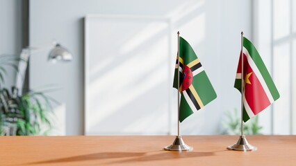 FLAGS OF DOMINICA AND SURINAME ON TABLE