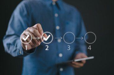 Businessman touching to tick correct mark in checklist to remind work task progressive for project...
