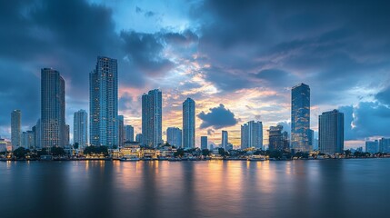 Skyline of modern Bangkok, Thailand. Majestic skyscrapers on the waterfront under the cloudy sky at twilight time.