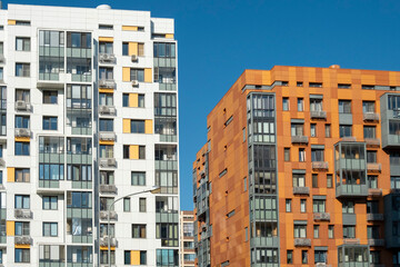 Modern European apartment blocks against a blue sky.