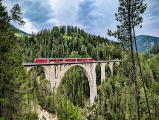 Swiss train over an old bridge at Wiesener Viadukt, Rhaetische Bahn (RhB). Davos Klosters Mountain