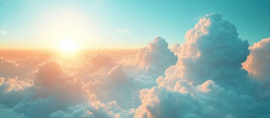 Golden sunset over a sea of clouds with a blue sky.