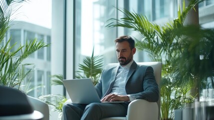 Businessman in a modern office working on a laptop