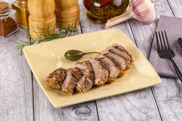 Roasted duck breast slices in the plate