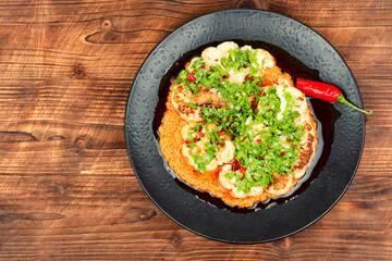 Cauliflower steaks with herb and sauce.