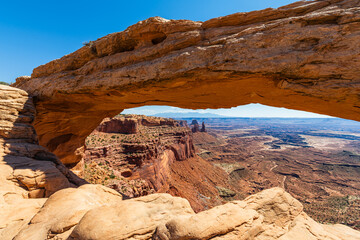The most famous landmark of the Island in the Sky District of Canyonlands national park in Utah USA - The Mesa Arch in a blue day.