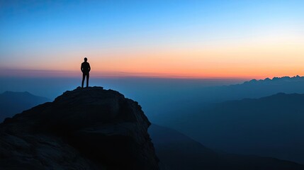 A solitary figure stands on a mountain peak, gazing at the colorful sunset sky, surrounded by serene landscapes and distant mountains.