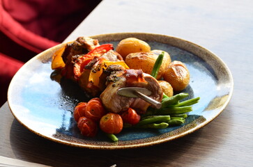 pork skewer with vegetables, served in a restaurant
