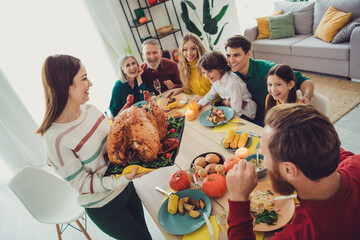 Photo of happy nice people celebrating thanksgiving day together serving main dish stuffed turkey indoors