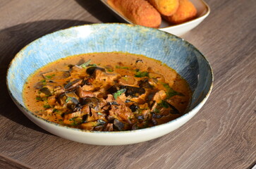 close up view of food served in restaurant on wooden table, mushroom goulash or ragout with fried...