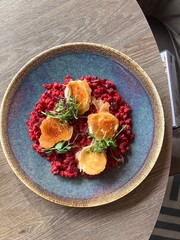 A vibrant and healthy vegetarian dish featuring barley risotto with roasted beetroot and grilled goat cheese. 
