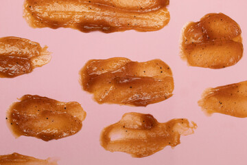 Texture of thick smear brown cosmetic face or body scrub cream