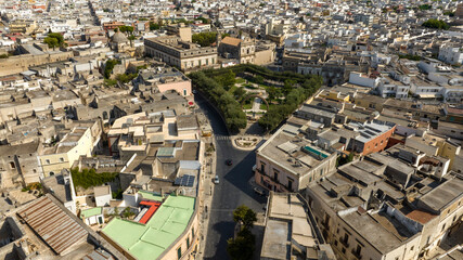 Aerial view of the Manduria municipal villa in the province of Taranto, Italy. In the public park there is a fountain and a war memorial.